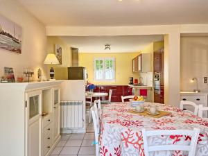 a kitchen and dining room with a table and chairs at Holiday Home Ar Mimoza - LBO301 by Interhome in Le Bono