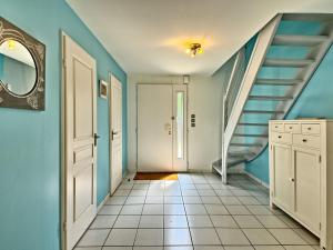 a hallway with blue walls and a staircase at Holiday Home Ar Mimoza by Interhome in Le Bono