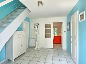 a staircase in a room with blue walls and white floors at Holiday Home Ar Mimoza by Interhome in Le Bono