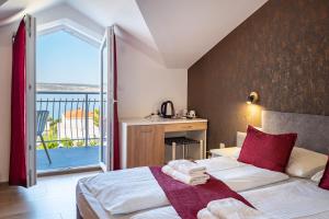 Posteľ alebo postele v izbe v ubytovaní Hotel Vicko
