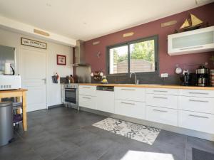a kitchen with white cabinets and a window at Holiday Home Hidel - TRP101 by Interhome in Plouarzel