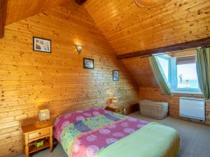 a bedroom with a bed in a wooden room at Holiday Home La Rose des Vents - YPO401 by Interhome in Yport