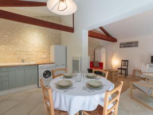 een keuken en eetkamer met een tafel en stoelen bij Holiday Home Domremy by Interhome in Saint-Palais-sur-Mer