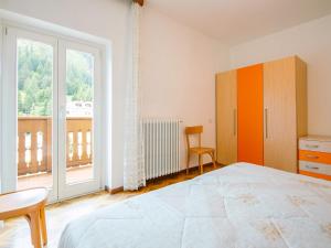 a bedroom with a bed and a large window at Apartment Pederiva - SOF740 by Interhome in Soraga +19 photos