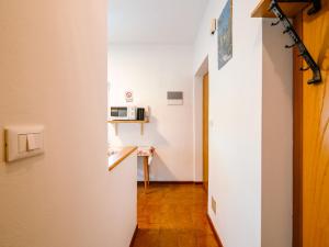 a hallway leading to a room with a microwave at Apartment Pederiva - SOF740 by Interhome in Soraga