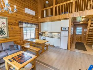 a kitchen and living room in a log cabin at Holiday Home Kaukonraitti 4 c 2 by Interhome in Ruka