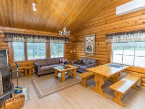 a living room with a couch and a table at Holiday Home Kaukonraitti 4 c 2 by Interhome in Ruka