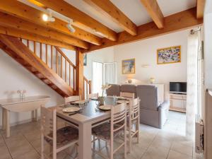 a kitchen and dining room with a table and chairs at Holiday Home Brive 2 by Interhome in Pontaillac