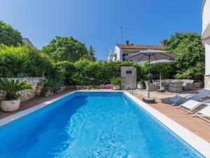 a swimming pool in a yard with a house at Apartment Romantika - ROJ105 by Interhome in Rovinj