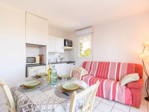 a living room with a table and a couch at Apartment Zéphyr-1 by Interhome in Arcachon +13 photos