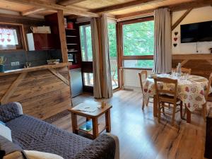 a living room with a table and chairs and a kitchen at Studio Castel des Roches-2 by Interhome in Saint-Gervais-les-Bains