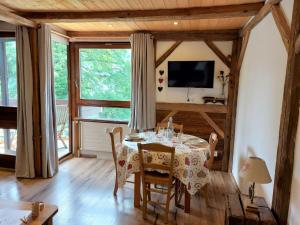 a dining room with a table with chairs and a television at Studio Castel des Roches-2 by Interhome in Saint-Gervais-les-Bains
