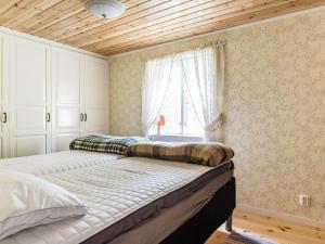 a bedroom with two beds and a window at Holiday Home Röshult by Interhome in Kyrkhult