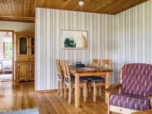 a dining room with a wooden table and chairs at Chalet Bengtstorp by Interhome in Gyttorp