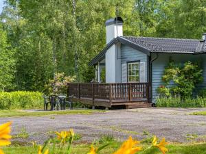 a small cabin with a deck and a table at Chalet Bengtstorp by Interhome in Gyttorp
