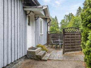 a patio with a table and a fence next to a house at Holiday Home Forneboda by Interhome in Kyrkhult