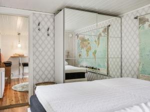 a bedroom with a large bed and a map on the wall at Chalet Ringsegård Höjden - HAL045 by Interhome in Falkenberg