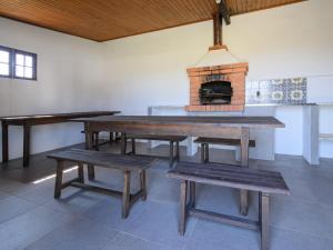 a room with a table and benches and a brick oven at Holiday Home De Carreço - CRR100 by Interhome in Carreço