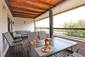 a table with a plate of food on a balcony at Marina Hill Apartment in Lagos