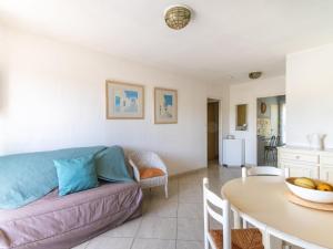 a living room with a couch and a table at Apartment Les Ilaires by Interhome in Le Lavandou