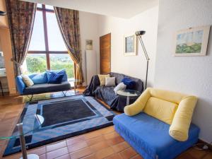 a living room with two couches and a table at Holiday Home Le Belvédère by Interhome in La Londe-les-Maures