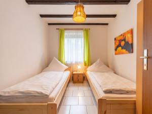 Un pat sau paturi într-o cameră la Apartment Am Hohen Bogen-71 by Interhome