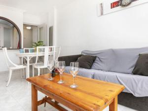 - un salon avec 2 verres à vin sur une table en bois dans l'établissement Apartment Jardines Family-4 by Interhome, à Salou