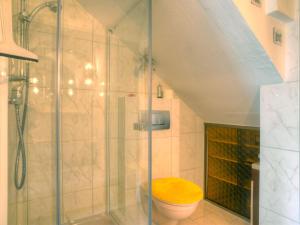 a bathroom with a toilet with a glass shower at Apartment Am Dohlenberg by Interhome in Schieder-Schwalenberg