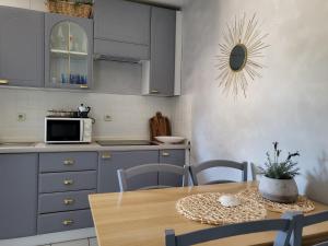 a kitchen with a table and a microwave oven at Apartments Grgic in Njivice