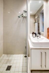 a bathroom with a shower and a sink at The Apartment in Mouille Point in Cape Town