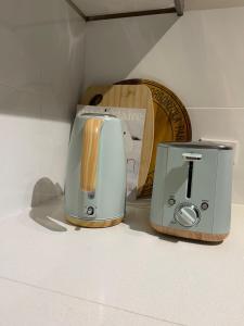 two toasters sitting on a counter next to a toaster at Charming & Cozy 2BR Cottage in Blacktown