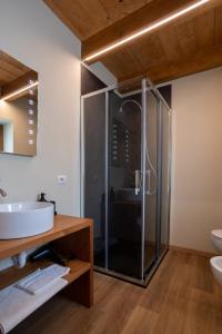 a bathroom with a glass shower and a sink at Bed & Bike La Stalla in Masera