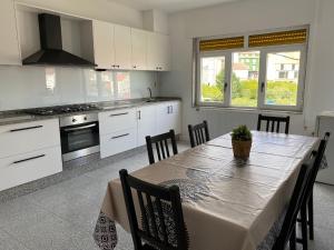 a kitchen with a table and chairs in a kitchen at A Xaneiriña in Camariñas