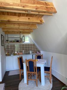 cocina con mesa y sillas en una habitación en Čivova brvnara, en Rudnik