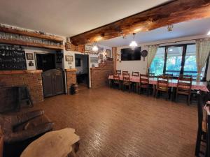 a living room with a table and chairs and a kitchen at Casa Brândușa in Bran