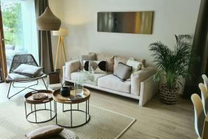 a living room with a couch and two tables at Villa ZAZ in Heki