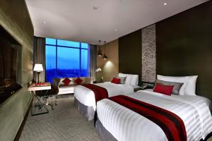 Postel nebo postele na pokoji v ubytování Aston Priority Simatupang Hotel and Conference Center
