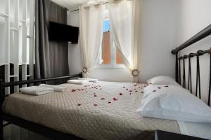 a bedroom with a bed with red roses on it at Villa Drosia in Volimes