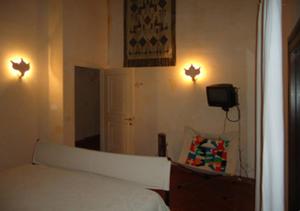 a bedroom with a bed and two lights on the wall at Villa Agosto in Stintino