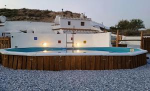 a large swimming pool in front of a house at Cuevas Azul in Baza