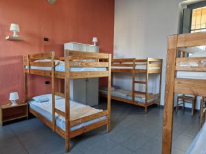 a group of bunk beds in a room at Ostello Costa Alta in Monza