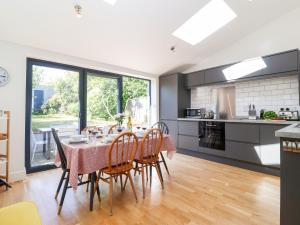 a kitchen and dining room with a table and chairs at Long View in Southwold