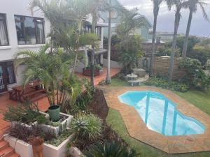 a swimming pool in the yard of a house at Lazydaze Super and Tubes in Jeffreys Bay