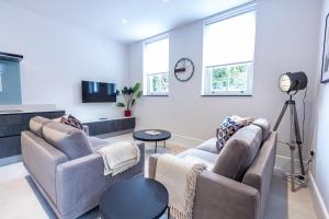 a living room with two couches and a table at Premier London Apartments Near Camden markets very close to tube stations by Sojo Stay in London