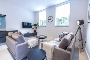 a living room with two couches and a table at Premier London Apartments Near Camden markets & very close to tube stations by Belvilla in London