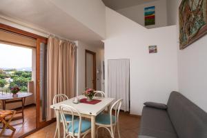 een woonkamer met een tafel en een bank bij Casa Olbiamare by Wonderful Italy in Olbia