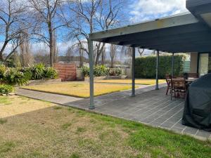 a covered patio with a table and chairs at Yass Valley Stays - Easy self check-in in Yass