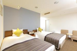 Postel nebo postele na pokoji v ubytování HOTEL MYSTAYS Utsunomiya
