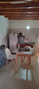 a living room with a table and a kitchen at LA PALMERA in Maipú