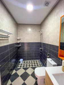 a bathroom with a toilet and a tiled floor at Visit Oued Laou - Florencia in Oued Laou